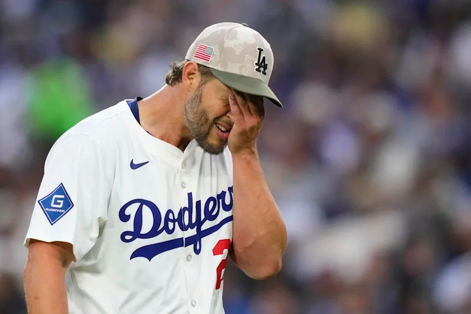 Dodgers starting pitcher Clayton Kershaw wipes his face during the third inning of an 11-9 loss to the Angels.