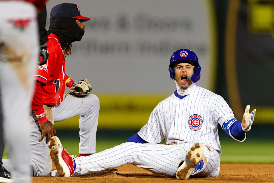South Bend Cubs infielder Cristian Hernandez, right, celebrates sliding safely into second base during a Minor League Baseball game between the South Bend Cubs and the Peoria Chiefs at Four Winds Field on Tuesday, April 8, 2025, in South Bend.