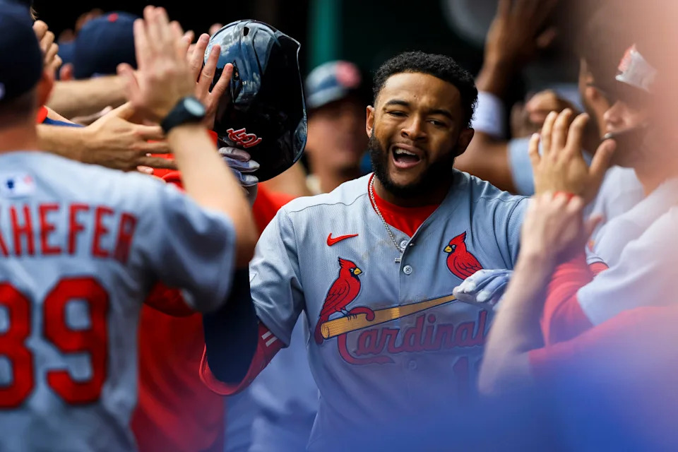 Victor Scott II (11) high fives teammates after hitting a three-run home run.Katie Stratman-Imagn Images