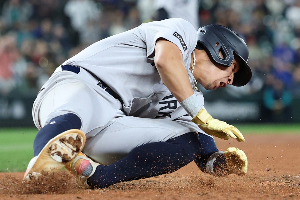 New York Yankees baseball player sliding into base.