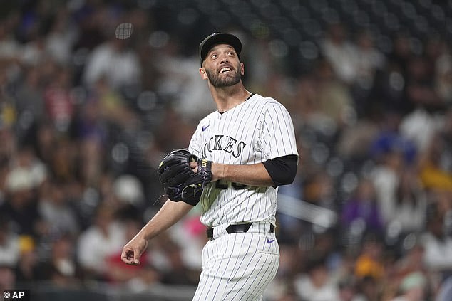 Jacob Stallings, usually a catcher, smiles as he watches one of his pitches fly over his head