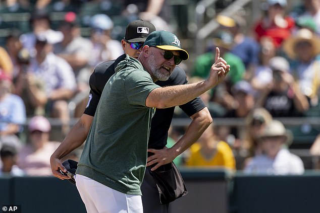 Mark Kotsay, front, argues with umpire Roberto Ortiz, back, leading to his ejection