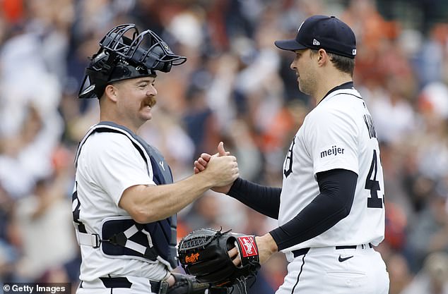 Catcher Jake Rogers of the Detroit Tigers celebrates with closing pitcher Tommy Kahnle after securing the win