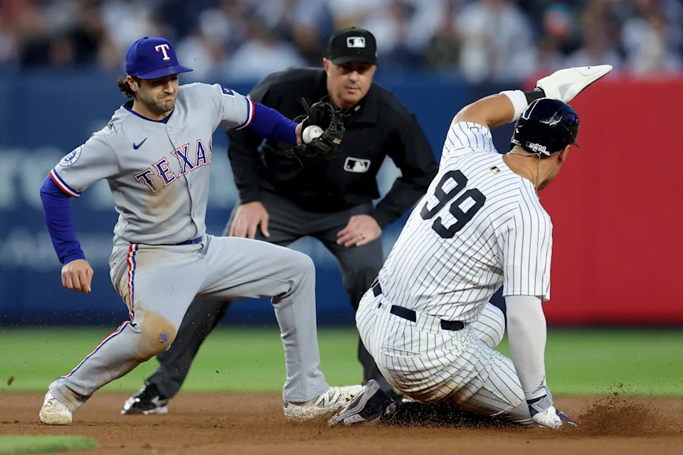 May 20, 2025; Bronx, New York, USA; New York Yankees right fielder Aaron Judge (99) steals second base ahead of a tag by Texas Rangers shortstop Josh Smith (8) during the fourth inning at Yankee Stadium.