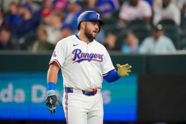 Texas Rangers' Jake Burger looks on during an at bat against the Athletics during the first inning of a baseball game Wednesday, April 30, 2025, in Arlington, TX. (AP Photo/Julio Cortez)