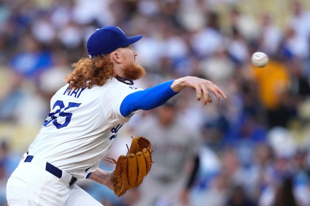 Dodgers starting pitcher Dustin May throws to the plate during...
