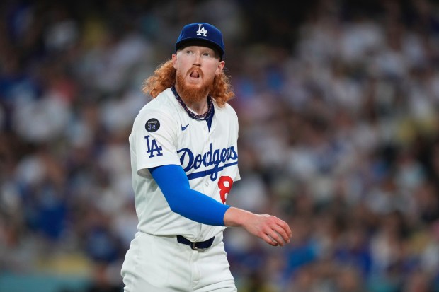 Dodgers starting pitcher Dustin May walks off the field after...