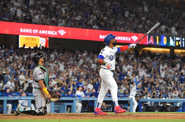 The Dodgers’ Teoscar Hernández, right, watches the flight of his...