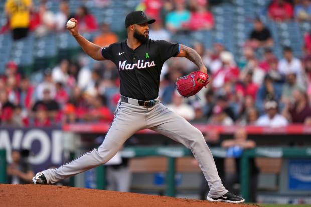 Miami Marlins starting pitcher Sandy Alcantara throws to the plate...