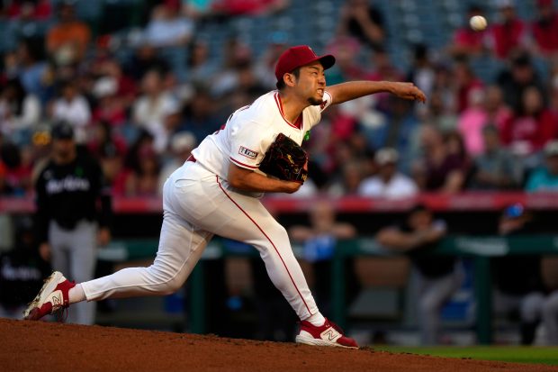 Angels starting pitcher Yusei Kikuchi throws to the plate during...