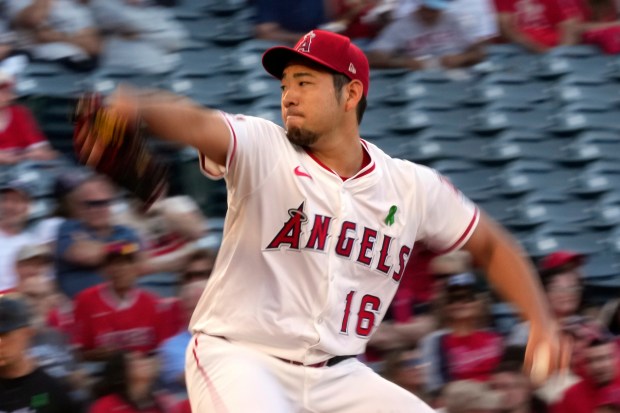 Angels starting pitcher Yusei Kikuchi throws to the plate during...