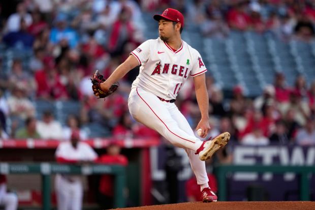 Angels starting pitcher Yusei Kikuchi throws to the plate during...
