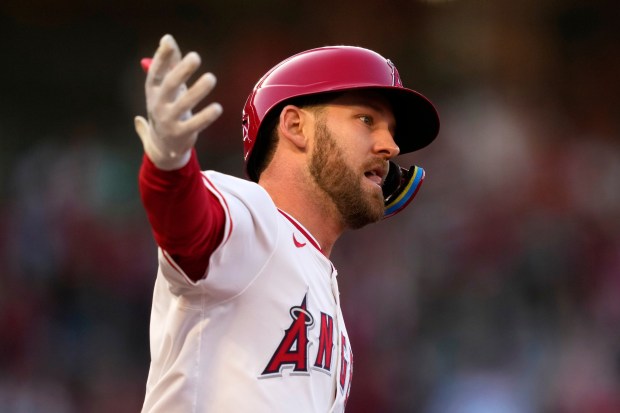 The Angels’ Taylor Ward gestures as he runs the bases...