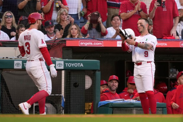 The Angels’ Taylor Ward, left, is congratulated by teammate Zach...