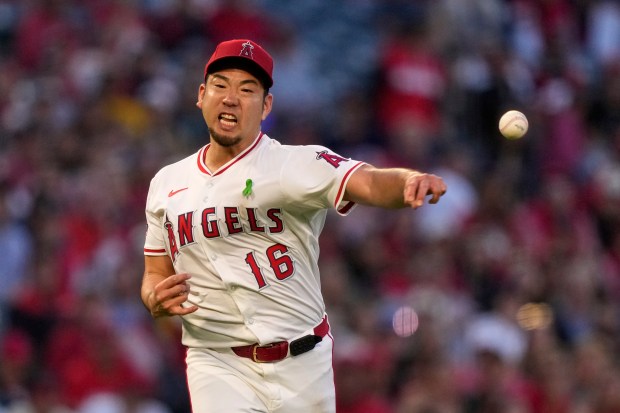 Angels starting pitcher Yusei Kikuchi attempts to throw out the...