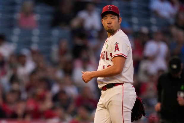 Angels starting pitcher Yusei Kikuchi gives a thumbs up after...