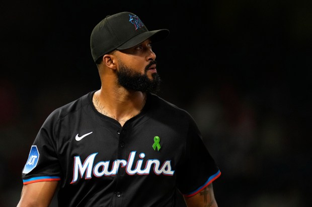 Miami Marlins starting pitcher Sandy Alcantara walks off the field...