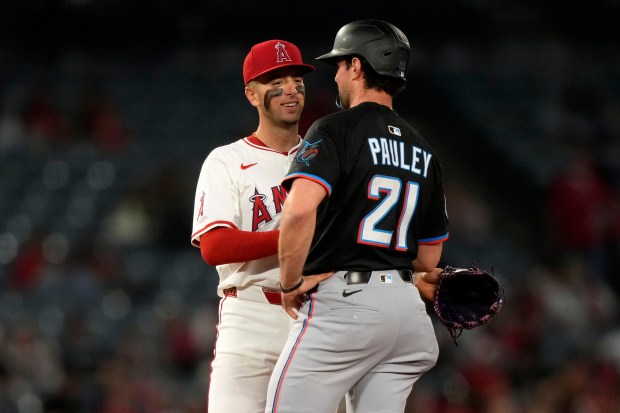 Angels shortstop Zach Neto, let, chats with Miami Marlins’ Graham...
