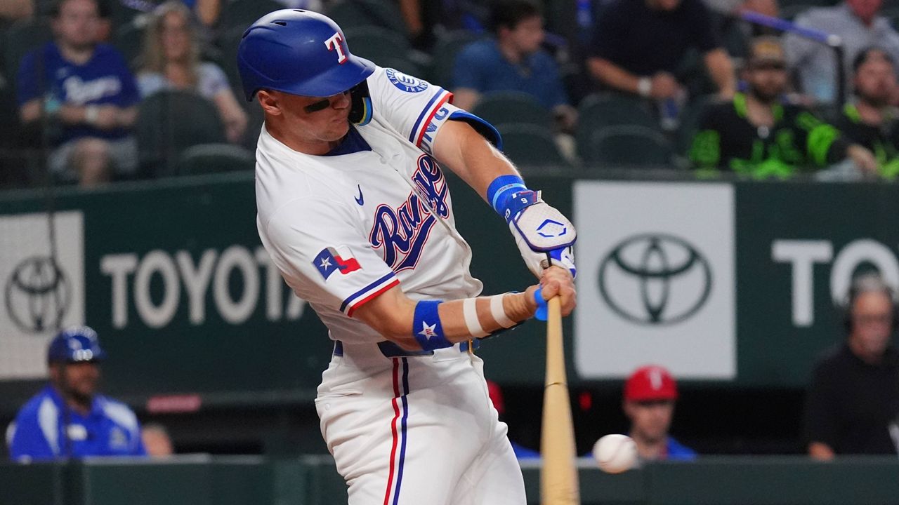 Texas Rangers' Josh Jung hits a home run during the first inning of a baseball game against the Colorado Rockies, Tuesday, May 13, 2025, in Arlington, Texas. (AP Photo/LM Otero)