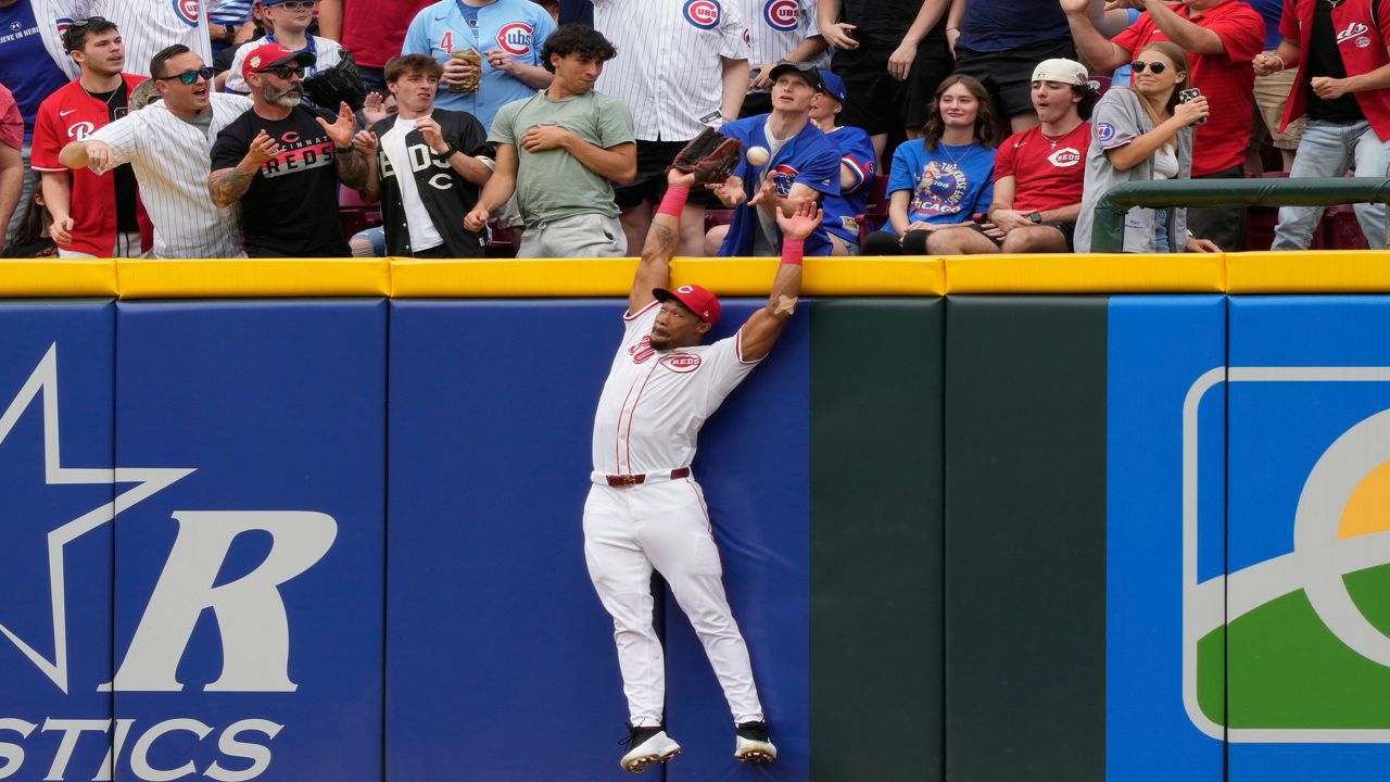 Chicago Cubs' Pete Crow-Armstrong, center, celebrates with Seiya Suzuki, left, and outfielder Kyle Tucker, right, after hitting a grand slam to right field during the seventh inning of a baseball game against the Cincinnati Reds, Friday, May 23, 2025, in Cincinnati.