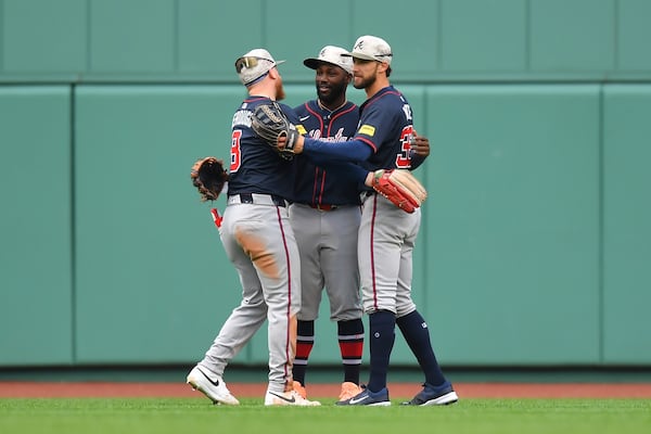 From left, Braves outfielders Alex Verdugo, Michael Harris II and Eli White celebrate Sunday's win over the Red Sox.