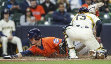 Houston Astros' Zach Dezenzo slides safety into home plate ahead of the tag by Milwaukee Brewers' Eric Haase (13) during the fifth inning of a baseball game, Wednesday, May 7, 2025, in Milwaukee. (AP Photo/Jeffrey Phelps)