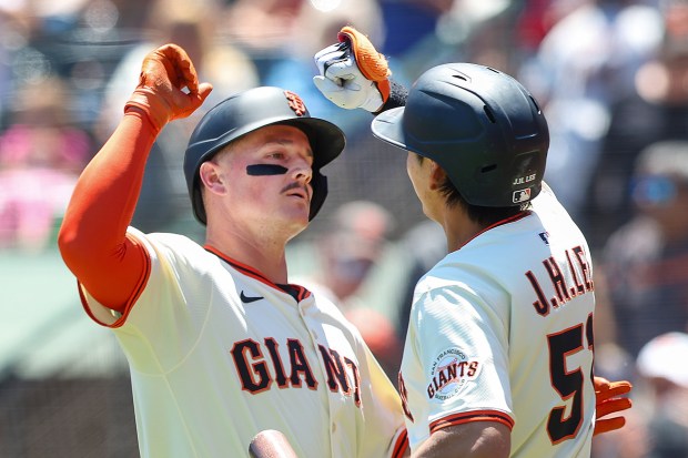 San Francisco Giants’ Matt Chapman is greeted by Jung Ho...