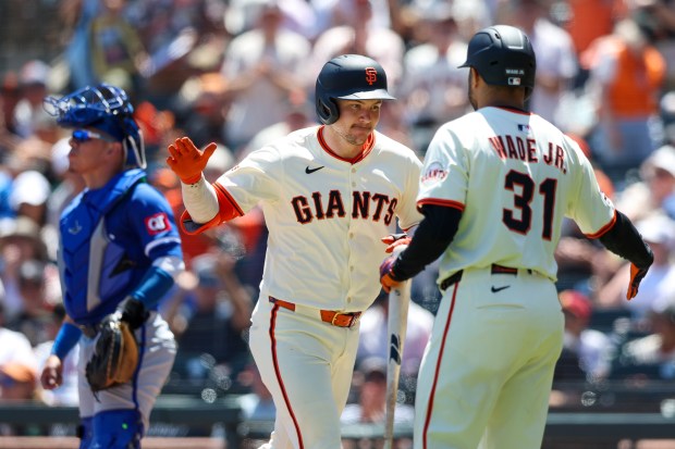 San Francisco Giants’ Patrick Bailey is greeted by LaMonte Wade...