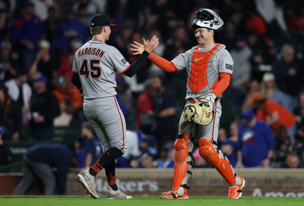 San Francisco Giants relief pitcher Kyle Harrison (45) and catcher Patrick Bailey celebrate after a victory over the Chicago Cubs at Wrigley Field in Chicago on May 6, 2025. (Chris Sweda/Chicago Tribune)