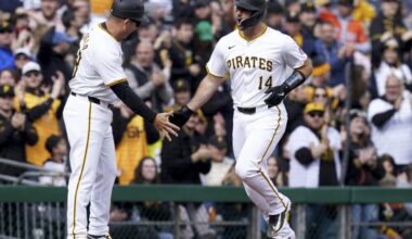 Pittsburgh Pirates' Joey Bart, right, is greeted by third base coach Mike Rabelo, left, after hitting a home run during the second inning of a baseball game against the Baltimore Orioles, Saturday, April 6, 2024, in Pittsburgh. (AP Photo/Matt Freed)