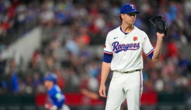 Texas Rangers starting pitcher Jacob deGrom, right, waits for a new ball as Toronto Blue Jays' Daulton Varsho, left, runs the bases after hitting a solo home run during the first inning of a baseball game, Monday, May 26, 2025, in Arlington, Texas. (AP Photo/Julio Cortez)