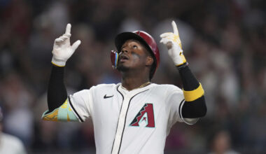 Arizona Diamondbacks' Geraldo Perdomo looks up as he arrives at home plate after hitting a home run...