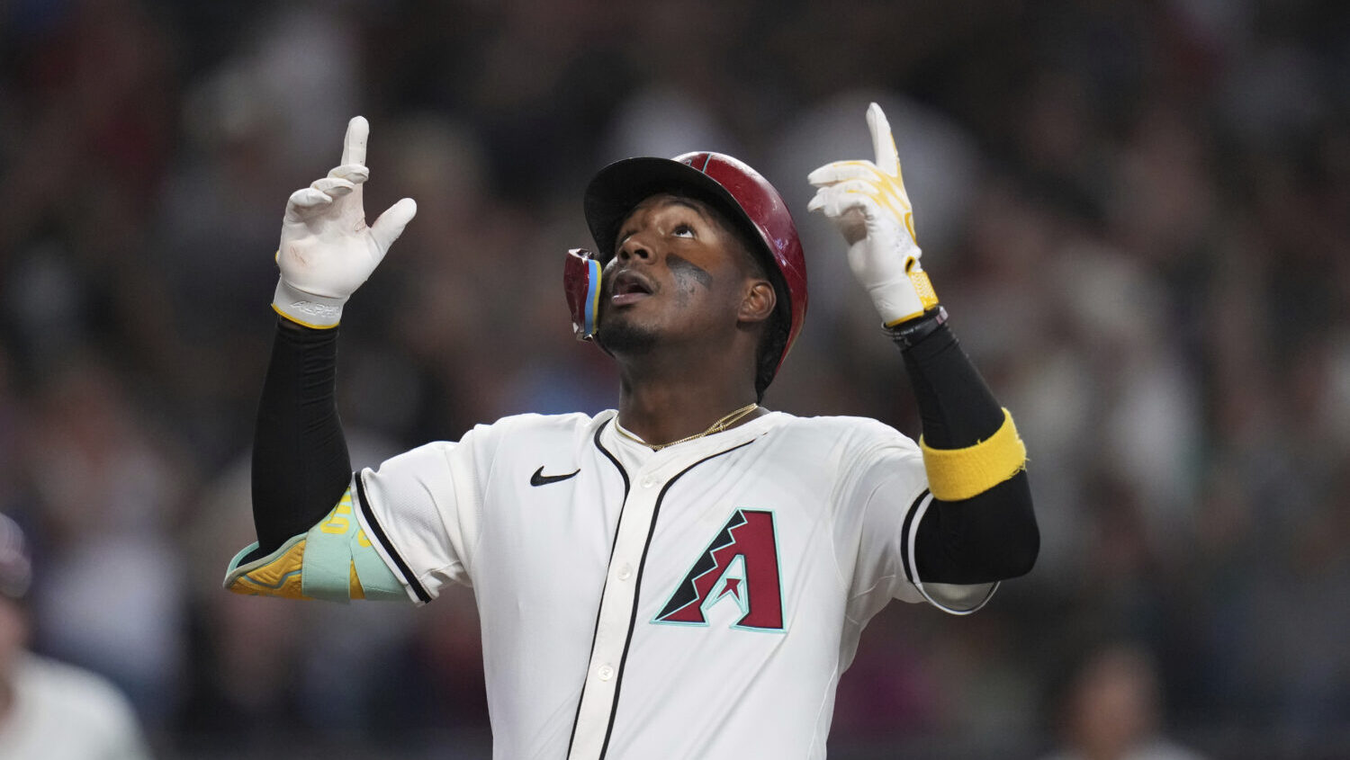 Arizona Diamondbacks' Geraldo Perdomo looks up as he arrives at home plate after hitting a home run...