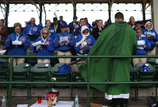 Fr. Burke Masters holds the final mass of the season before Game 5 of the World Series between the Cubs and Indians at Wrigley Field on Oct. 30, 2016, in Chicago. (John J. Kim/Chicago Tribune)
