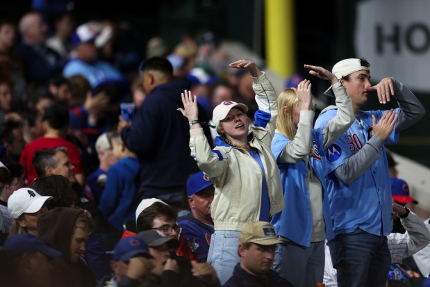 Cubs fans dance to "YMCA" during a game against the Rockies on May 28, 2025, at Wrigley Field. (Audrey Richardson/Chicago Tribune)