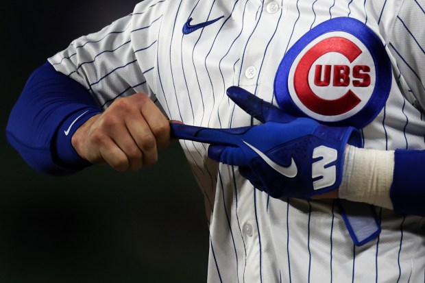 Cubs second baseman Nico Hoerner pulls off his batting glove after drawing a walk during the seventh inning against the Rockies on May 28, 2025, at Wrigley Field. (Audrey Richardson/Chicago Tribune)