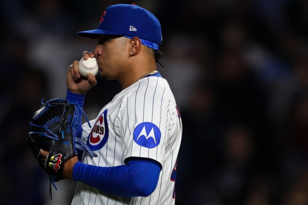 Cubs reliever Daniel Palencia kisses a ball after striking out Rockies catcher Hunter Goodman to seal a 2-1 win against the Rockies on May 28, 2025, at Wrigley Field. (Audrey Richardson/Chicago Tribune)