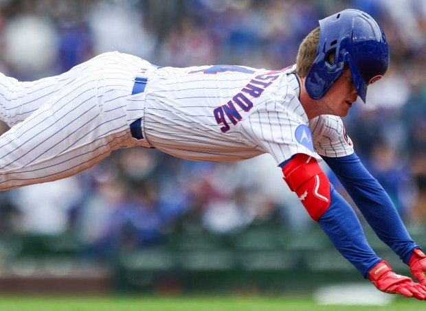 The helmet of Chicago Cubs outfielder Pete Crow-Armstrong (4) slips down onto his face as he slides into third base after hitting a triple in the first inning against the Chicago White Sox at Wrigley Field on Sunday, May 18, 2025. (Eileen T. Meslar/Chicago Tribune)