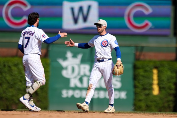 Chicago Cubs shortstop Dansby Swanson (7) high-fives second baseman Nico Hoerner (2) after beating the Chicago White Sox 6-2 at Wrigley Field on Sunday, May 18, 2025. (Eileen T. Meslar/Chicago Tribune)