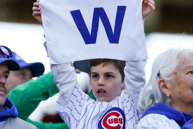 A Chicago Cubs fan holds up a "W" towel after the Chicago Cubs defeated the Chicago White Sox 6-2 at Wrigley Field on Sunday, May 18, 2025. (Eileen T. Meslar/Chicago Tribune)