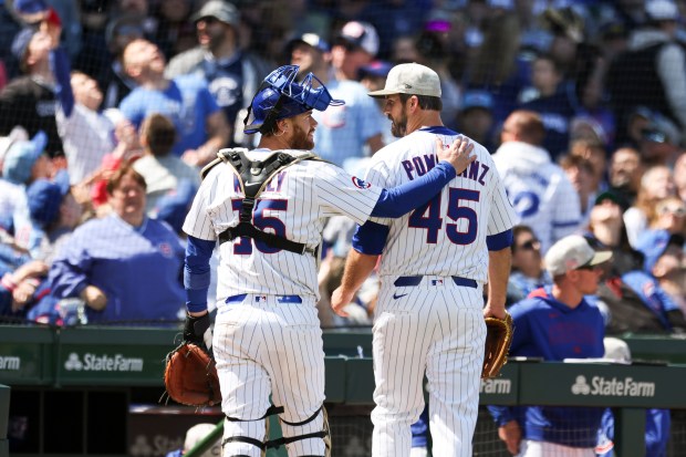 Chicago Cubs catcher Carson Kelly (15) pats teammate pitcher Drew Pomeranz (45) on the back after getting out of the top of the sixth inning against the Chicago White Sox at Wrigley Field on Sunday, May 18, 2025. (Eileen T. Meslar/Chicago Tribune)