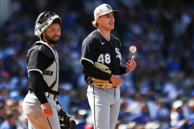 Chicago White Sox catcher Edgar Quero (7) and pitcher Jonathan Cannon (48) wait while the Chicago White Sox challenge third baseman Vidal Bruján (17) being safe at home plate in the sixth inning at Wrigley Field on Sunday, May 18, 2025. (Eileen T. Meslar/Chicago Tribune)