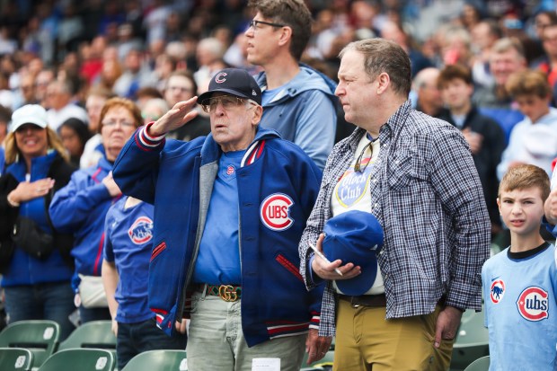 A Chicago Cubs fan salutes while the national anthem is performed before the game against the Chicago White Sox at Wrigley Field on Sunday, May 18, 2025. (Eileen T. Meslar/Chicago Tribune)