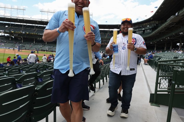 Fans walk to their seats with filled beer bats before a Cubs-White Sox game on May 17, 2025, at Wrigley Field. (John J. Kim/Chicago Tribune)