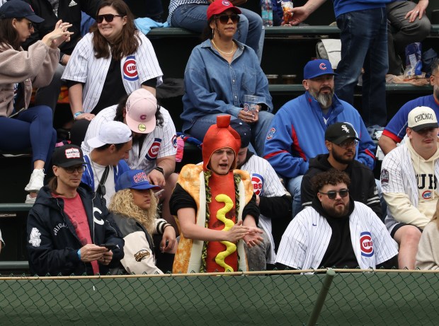 A fan wearing a hot dog costume cheers players warming up before a Cubs-White Sox game on May 17, 2025, at Wrigley Field. (John J. Kim/Chicago Tribune)