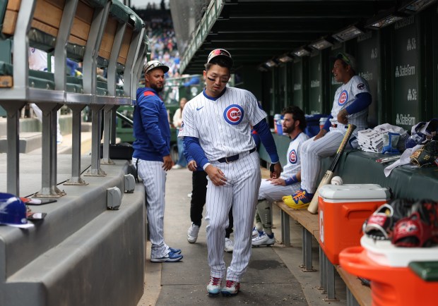 Cubs left fielder Seiya Suzuki makes a swagger gesture while walking through the dugout before a game against the White Sox on May 17, 2025, at Wrigley Field. (John J. Kim/Chicago Tribune)
