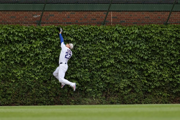 Cubs left fielder Seiya Suzuki leaps for an out-of-reach home run ball hit by White Sox shortstop Chase Meidroth in the first inning on May 17, 2025, at Wrigley Field. (John J. Kim/Chicago Tribune)