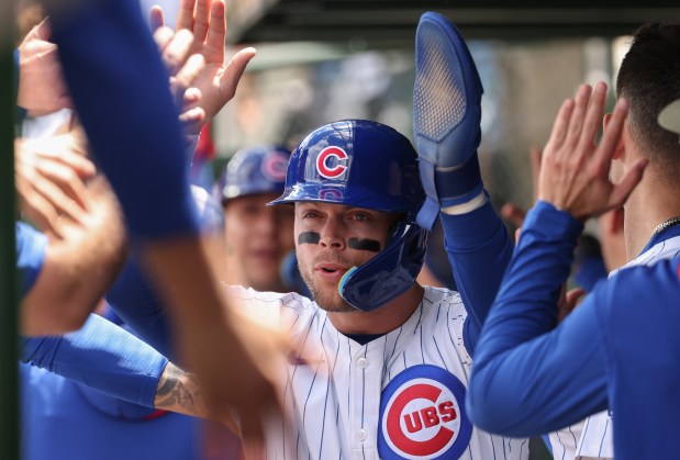 Cubs second baseman Nico Hoerner is congratulated after scoring on a two-run single by center fielder Pete Crow-Armstrong in the second inning against the White Sox on May 17, 2025, at Wrigley Field. (John J. Kim/Chicago Tribune)