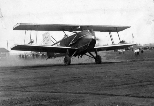 The National Air Transport Curtiss Carrier Pidgeon corporation plane, christened Miss Chicago, is shown taking off with a load of mail that would eventually get to Dallas, Texas during the opening ceremonies of the city's new air field, Chicago Municipal Airport, at 63rd Street and Cicero Avenue in Chicago on May 8, 1926. Editors note: this historic print shows some hand painting. (Chicago Tribune historical photo)