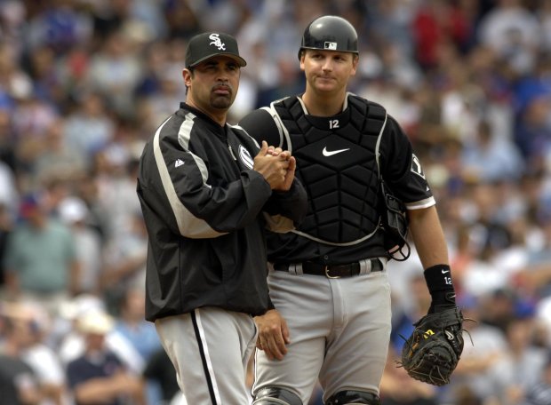 White Sox manager Ozzie Guillen, left, and catcher A.J. Pierzynski wait for a new pitcher to take the mound against the Cubs on May 21, 2005, at Wrigley Field. (Bonnie Trafelet/Chicago Tribune)
